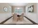 Cozy dining room features hardwood floors, custom trim and wainscoting with abundant natural light at 2370 Burch Cir, Brookhaven, GA 30319