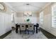 Dining room featuring wainscoting, a modern chandelier, and ample natural light at 2370 Burch Cir, Brookhaven, GA 30319