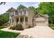 Elegant two-story home boasting a covered front porch, well-manicured landscaping, and a two-car garage with a basketball hoop at 2370 Burch Cir, Brookhaven, GA 30319