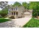 Beautifully landscaped home with a spacious driveway and a basketball hoop near the garage at 2370 Burch Cir, Brookhaven, GA 30319