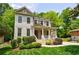 Charming two-story house with a welcoming front porch, lush landscaping, and classic architectural details at 2370 Burch Cir, Brookhaven, GA 30319