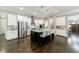 Spacious kitchen with stainless appliances, granite counters, island with seating and open access to the entry at 2370 Burch Cir, Brookhaven, GA 30319