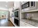 Gourmet kitchen features stainless steel appliances, granite countertops and custom white cabinets at 2370 Burch Cir, Brookhaven, GA 30319