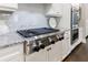A contemporary kitchen featuring a stainless steel stove top, granite countertops and white cabinetry at 2370 Burch Cir, Brookhaven, GA 30319
