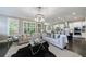 Bright and airy living room featuring hardwood floors, modern lighting, and an open floor plan to the kitchen at 2370 Burch Cir, Brookhaven, GA 30319
