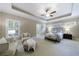 Spacious primary bedroom with tray ceiling, neutral paint, carpet, and window with plantation shutters at 2370 Burch Cir, Brookhaven, GA 30319