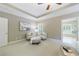 Sitting area with chairs, ottoman, plantation shutters, carpet, and doorway to ensuite bath at 2370 Burch Cir, Brookhaven, GA 30319