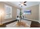 Home office with a glass desk, neutral colors, and natural light from shuttered windows at 2370 Burch Cir, Brookhaven, GA 30319