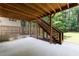 Covered back patio with wooden stairs leading to a large backyard at 2370 Burch Cir, Brookhaven, GA 30319