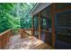 Relaxing screened-in porch offers views to lush backyard with wooden railing at 2370 Burch Cir, Brookhaven, GA 30319