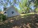 This backyard features a fenced-in yard, lush lawn, and space for recreation with mature shade trees at 5108 Hackett Ne St, Covington, GA 30014
