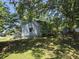 This backyard showcases a lush green lawn and mature trees providing ample shade at 5108 Hackett Ne St, Covington, GA 30014