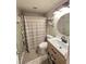 Modern bathroom with shower, toilet, vanity, and a round mirror at 5108 Hackett Ne St, Covington, GA 30014