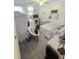 Cozy bedroom with neutral tones and a ceiling fan with a light fixture at 5108 Hackett Ne St, Covington, GA 30014