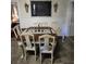 Charming dining area with farmhouse-style table, six chairs, and chalkboard wall decor at 5108 Hackett Ne St, Covington, GA 30014