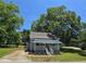 Charming single-story home with a welcoming porch and beautiful landscaping surrounded by mature trees at 5108 Hackett Ne St, Covington, GA 30014
