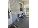 Inviting front porch with chairs, pillows and watering can, perfect for relaxing and enjoying the quiet outdoors at 5108 Hackett Ne St, Covington, GA 30014