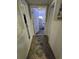 Hallway with patterned rug leading to another room with bright, inviting lighting at 5108 Hackett Ne St, Covington, GA 30014