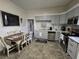Updated kitchen with modern appliances, white backsplash and cabinets plus a dining area, perfect for Gathering meals at 5108 Hackett Ne St, Covington, GA 30014