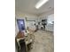 Well lit Kitchen with white cabinets and stainless steel appliances, next to a dining area with a wooden table at 5108 Hackett Ne St, Covington, GA 30014
