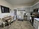 Updated kitchen showcasing stainless steel appliances, new cabinets, tile backsplash, and adjacent dining area at 5108 Hackett Ne St, Covington, GA 30014