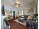 A comfortable living room with an L shaped sofa, hardwood floors, and plenty of space for entertaining guests at 5108 Hackett Ne St, Covington, GA 30014