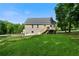 Spacious backyard with lush green grass and a wooden deck connected to the house at 71 Headland Ct, Rockmart, GA 30153