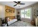 Charming Bedroom featuring a cozy crib, accent wall, and stylish decor at 71 Headland Ct, Rockmart, GA 30153