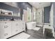 Primary bathroom featuring a soaking tub, double vanity, walk-in shower, and tiled walls at 918 Washington Sw St, Atlanta, GA 30315