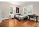 Bright bedroom with hardwood floors, desk, and a sports flag above the bed at 918 Washington Sw St, Atlanta, GA 30315