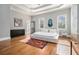 Sun-filled bedroom with hardwood floors, tray ceilings, and neutral walls that provide a calming atmosphere at 918 Washington Sw St, Atlanta, GA 30315