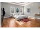 Bright bedroom with tray ceiling, hardwood floors, and large windows offering plenty of sunlight at 918 Washington Sw St, Atlanta, GA 30315