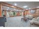 Spacious basement with wood paneled walls, carpeted floors, and ample natural light at 1325 Starboard Way, Cumming, GA 30041