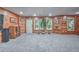 Finished basement with knotty pine walls, neutral carpet, natural light, and access to the outdoors at 1325 Starboard Way, Cumming, GA 30041
