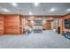 Basement featuring wood paneled walls, carpeted floors, and neutral furniture at 1325 Starboard Way, Cumming, GA 30041