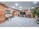 Basement featuring wood paneled walls, carpeted floors, and neutral furniture at 1325 Starboard Way, Cumming, GA 30041