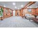 Basement featuring wood paneled walls, carpeted floors, and neutral furniture at 1325 Starboard Way, Cumming, GA 30041