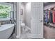 Bright main bathroom offers marble walls and floors, and views to the water closet and wardrobe at 1325 Starboard Way, Cumming, GA 30041