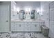 Stylish main bathroom offers double vanities, marble countertops and tiled floors at 1325 Starboard Way, Cumming, GA 30041