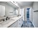 Stylish bathroom features dual sinks, a large mirror, and a glass-enclosed shower with marble-like tile at 1325 Starboard Way, Cumming, GA 30041