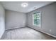 Bright bedroom with a window, carpet, and neutral walls, creating a serene and inviting atmosphere at 1325 Starboard Way, Cumming, GA 30041