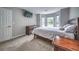Cozy bedroom featuring neutral colors, carpet flooring, bay window and a TV mounted on the wall at 1325 Starboard Way, Cumming, GA 30041