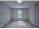 A bedroom features gray walls, carpet flooring and a window allowing natural light at 1325 Starboard Way, Cumming, GA 30041
