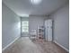 Bright bedroom with neutral walls, plush carpet, and a window bringing in natural light at 1325 Starboard Way, Cumming, GA 30041