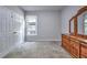 This bedroom features neutral carpeting, a window, and closet space at 1325 Starboard Way, Cumming, GA 30041