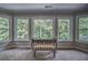 Bright and sunny sitting area off of bedroom features three large windows and stylish bench at 1325 Starboard Way, Cumming, GA 30041