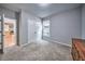 This bedroom includes neutral carpeting, a window, and closet space at 1325 Starboard Way, Cumming, GA 30041