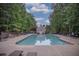 Inviting community pool with ample lounge seating, umbrellas, and a charming pool house at 1325 Starboard Way, Cumming, GA 30041