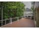 View of a spacious deck with outdoor seating and a gazebo, surrounded by lush greenery at 1325 Starboard Way, Cumming, GA 30041