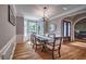 Formal dining room featuring hardwood floors, a bay window, and elegant chandelier at 1325 Starboard Way, Cumming, GA 30041